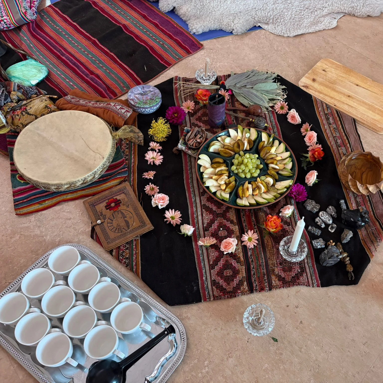 Ceremonial mesa with fruit offerings, flowers and candles