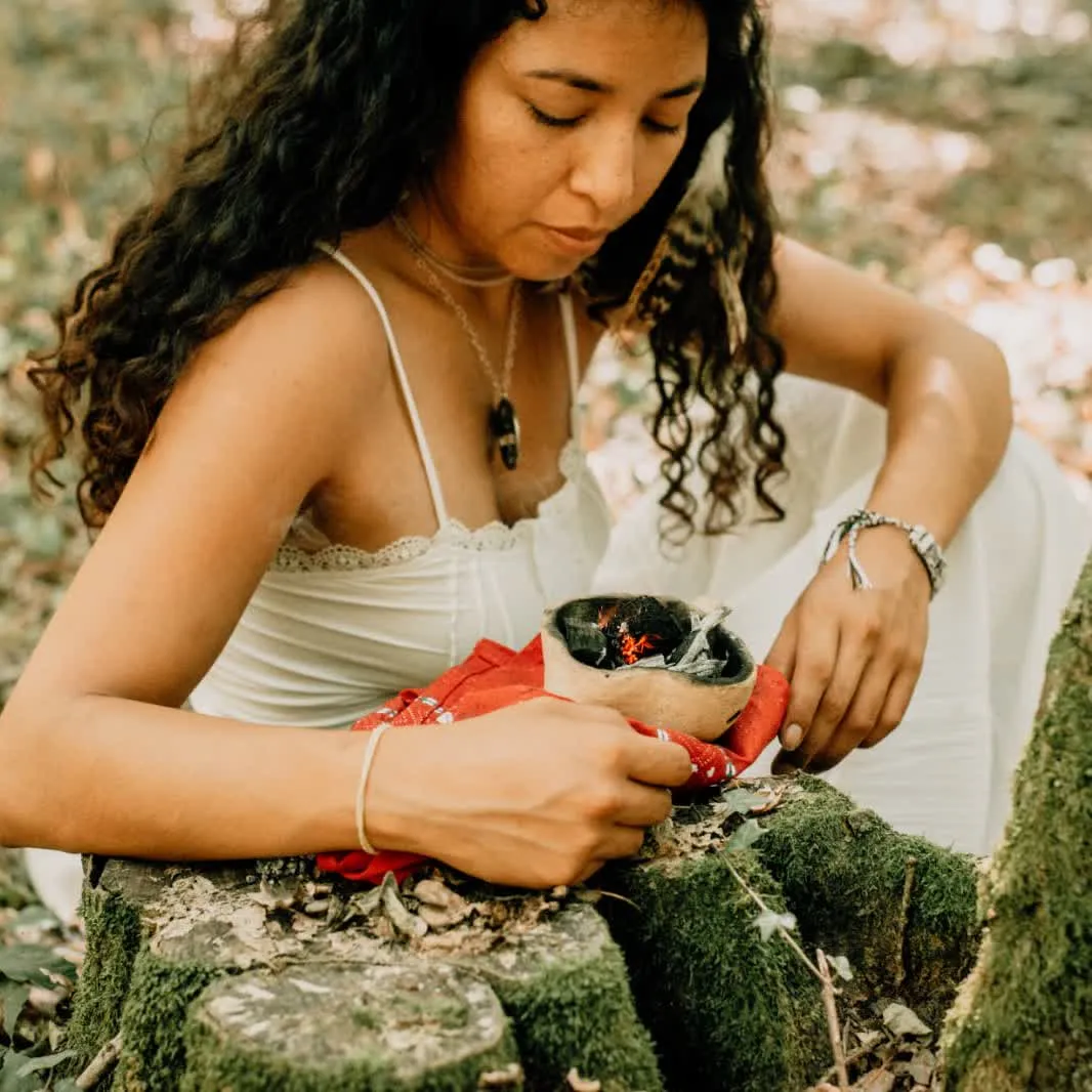 Mar seated on the forest floor — blue-toned, mysterious
