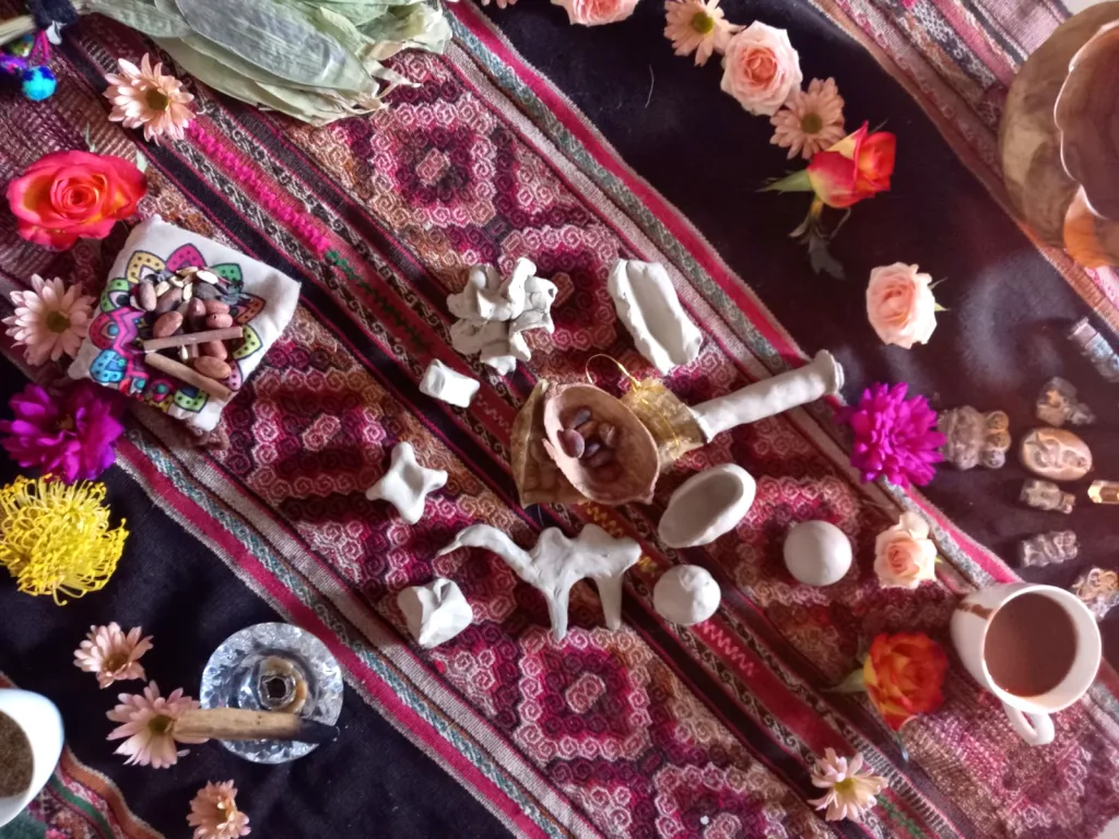 Sacred objects, flowers, and ceremonial tools arranged on a mesa